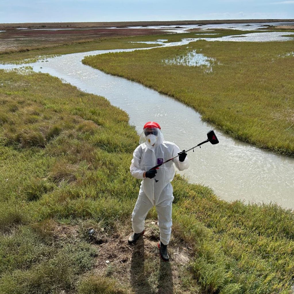 Person in protective clothing on nature reserve